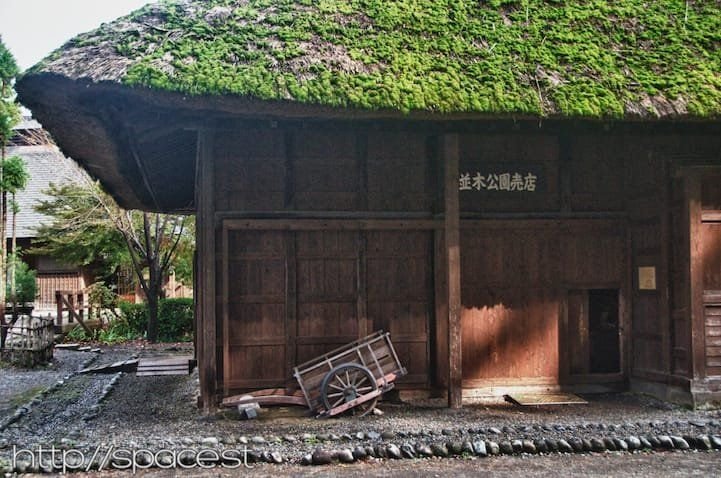 the old thatched roof workers' quarters and horse stables