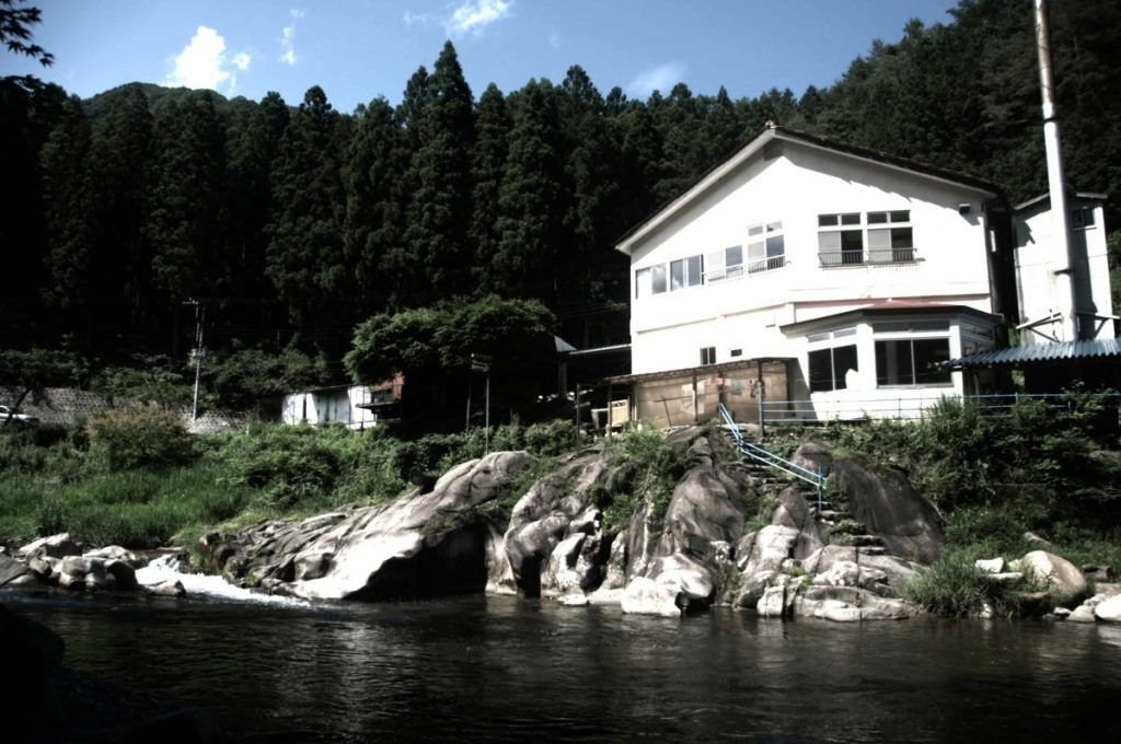 Earth Hostel Nikko Riverhouse — backpacker hostel on the Kurokawa River, mountains of Nikko, Japan
