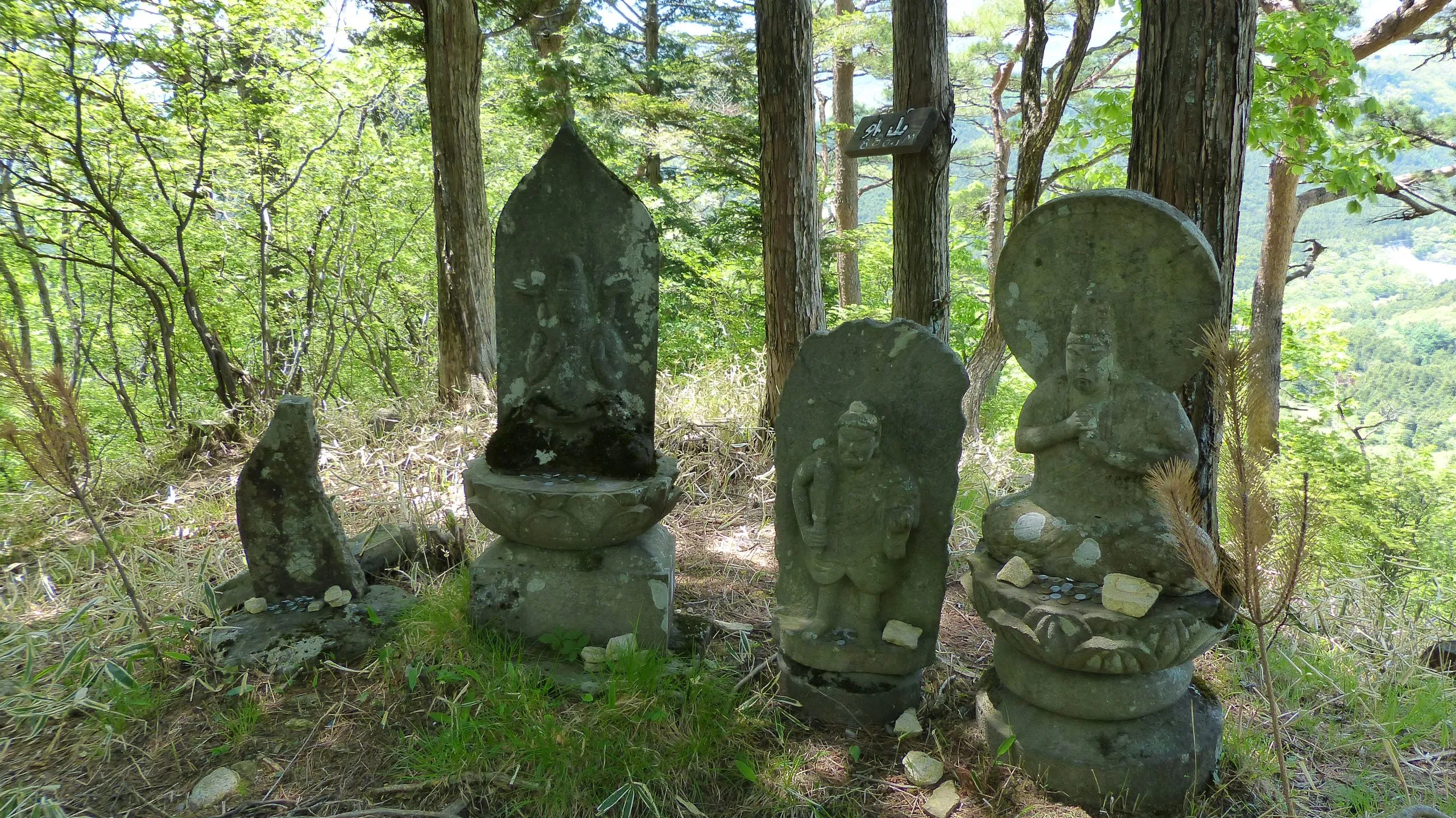 Bishamonten and weathered stone statues at the Mount Toyama summit, Nikko Japan