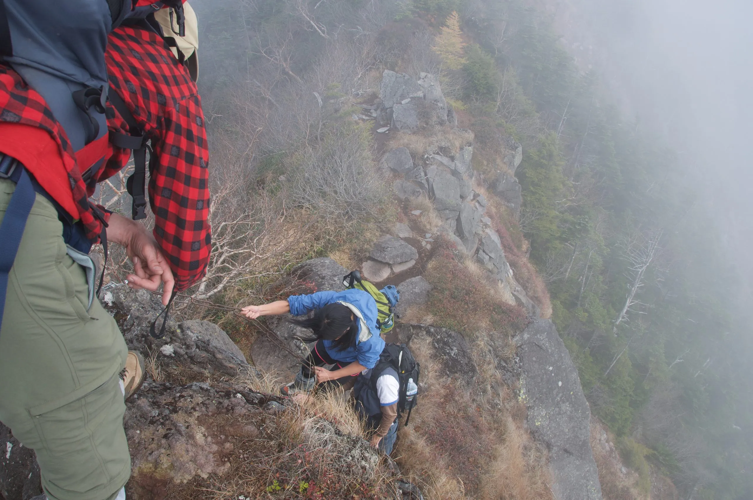 Hikers on the chain-assisted section below the summit, Nyoho Mountain hiking trail, Nikko Japan