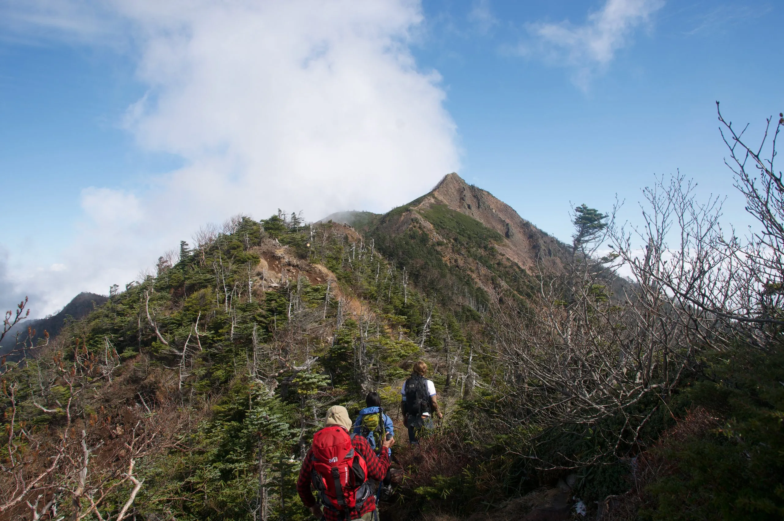 Hikers on the upper ridge with the summit ahead, Nyoho Mountain hiking trail, Nikko Japan