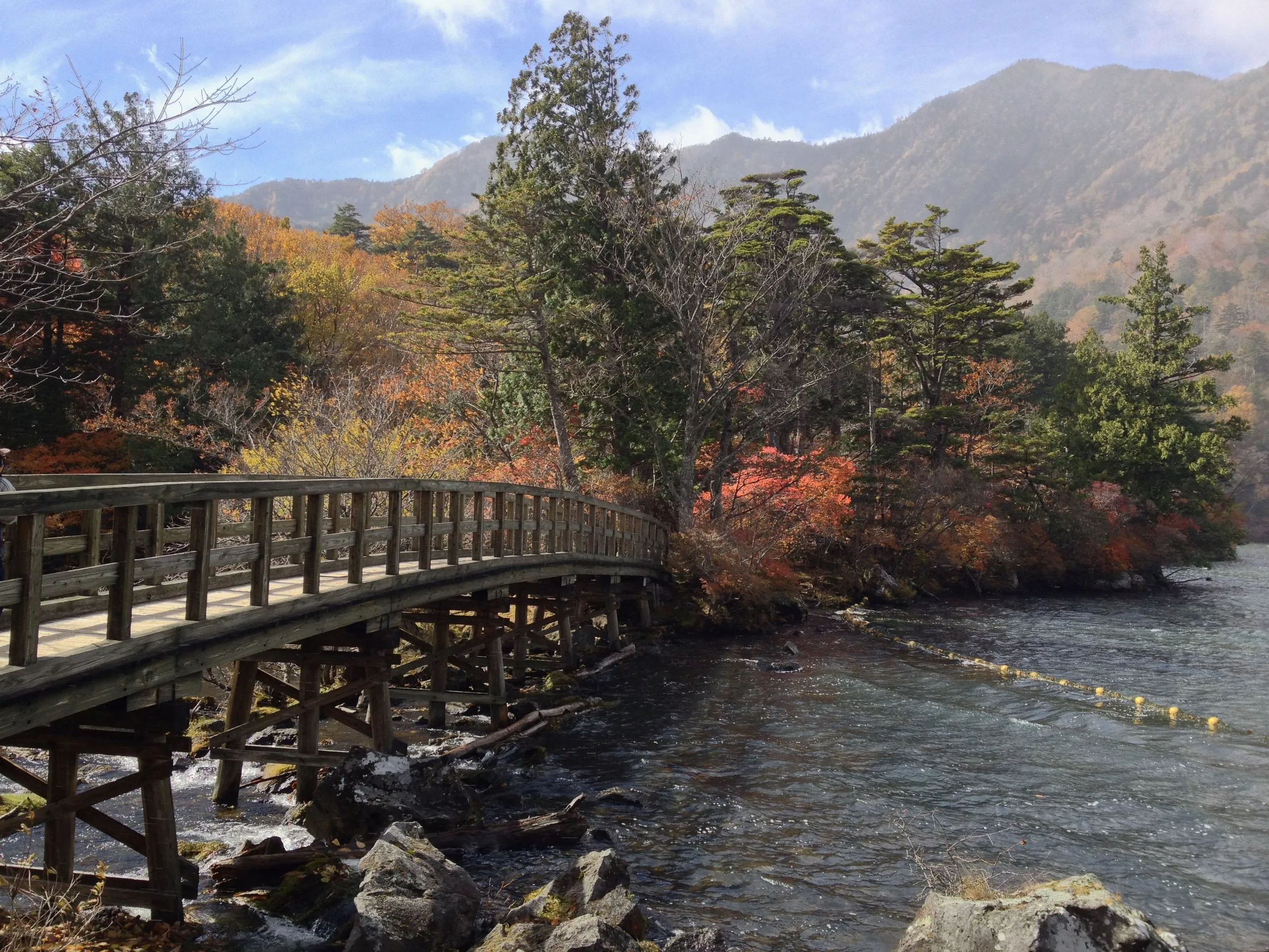 Arched wooden bridge over the Lake Yu outlet above Yu Falls, Nikko Japan