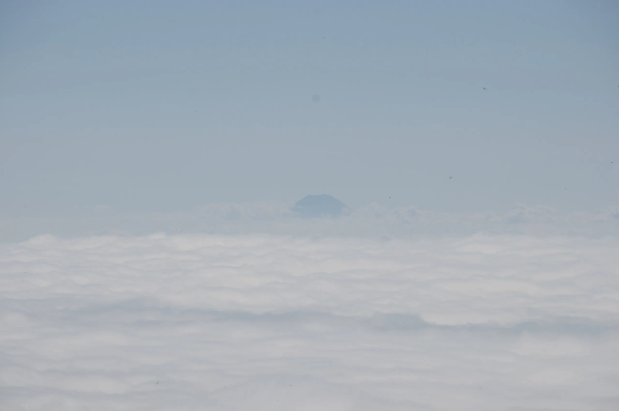 Distant Mount Fuji seen from the summit of Mount Nantai, Nikko Japan