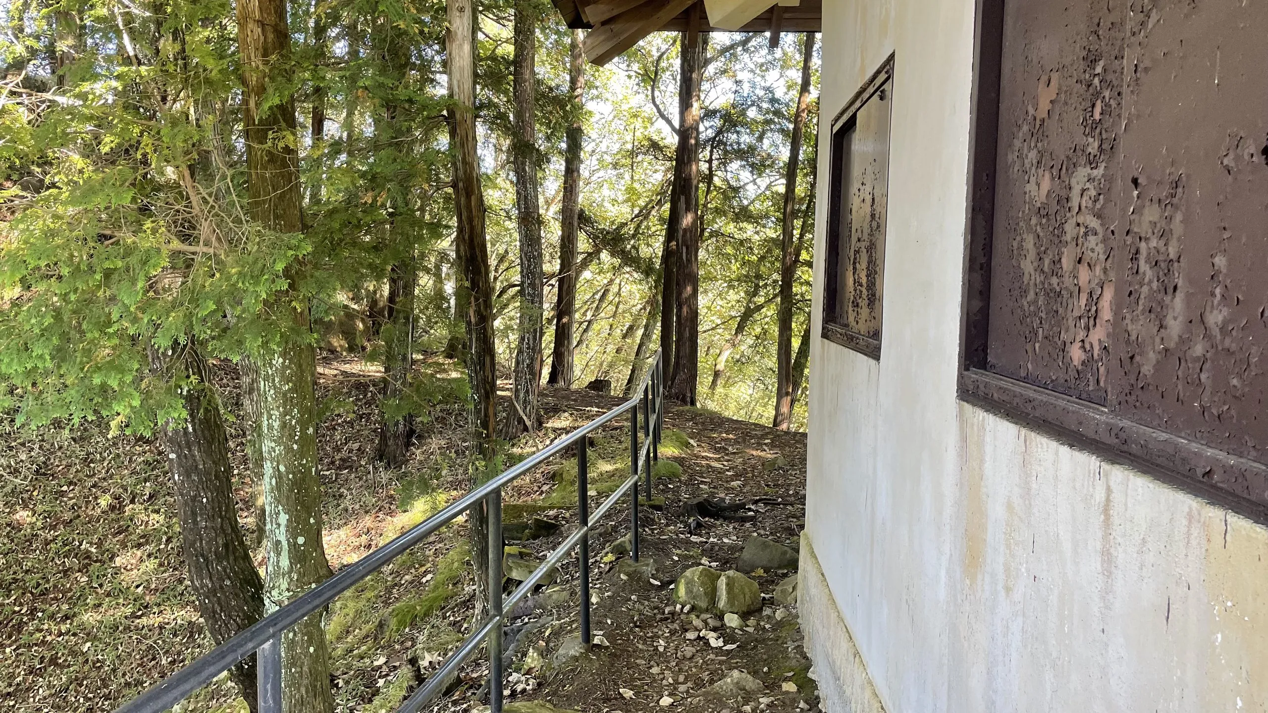 Handrail beside the storage shed where the Mount Toyama hiking trail continues, Nikko Japan