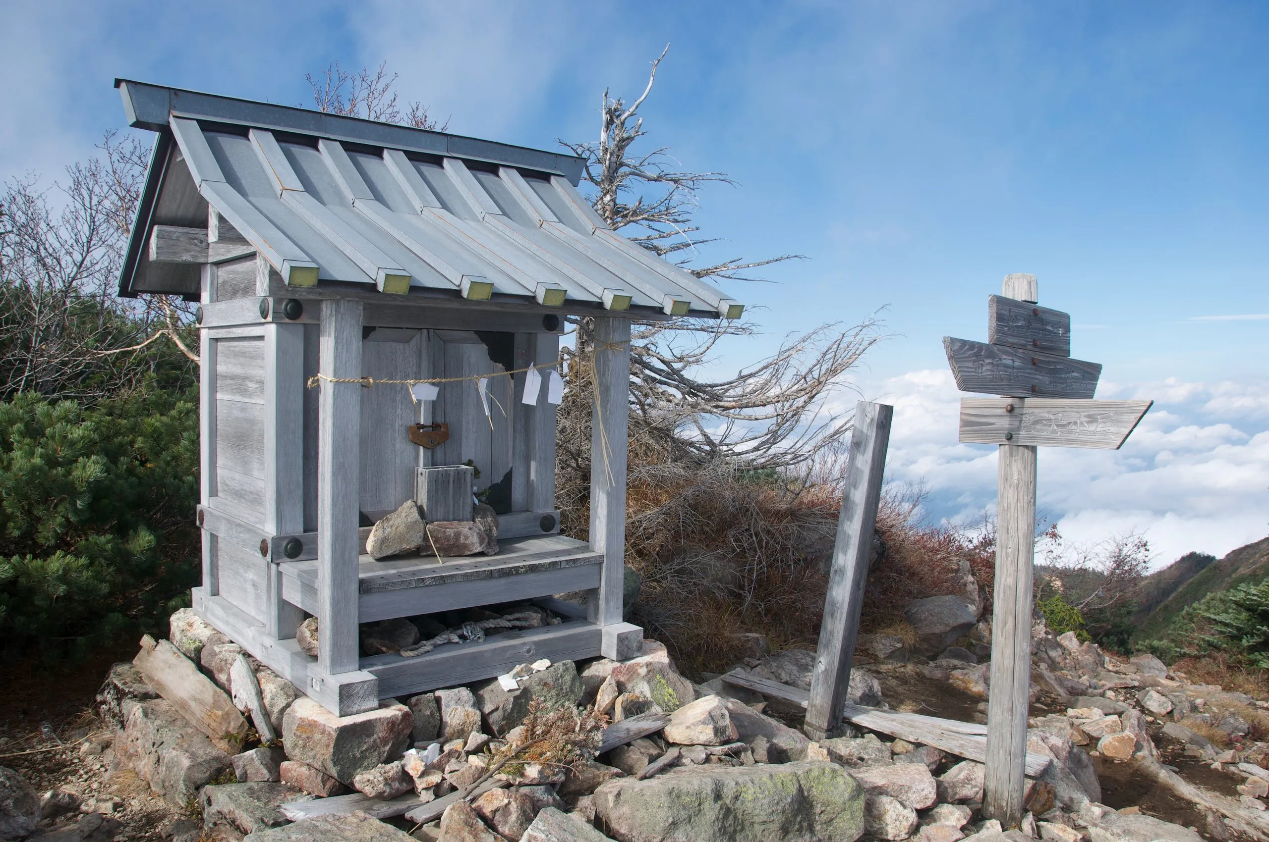 Small wooden shrine on the summit above the clouds, Nyoho Mountain hiking trail, Nikko Japan