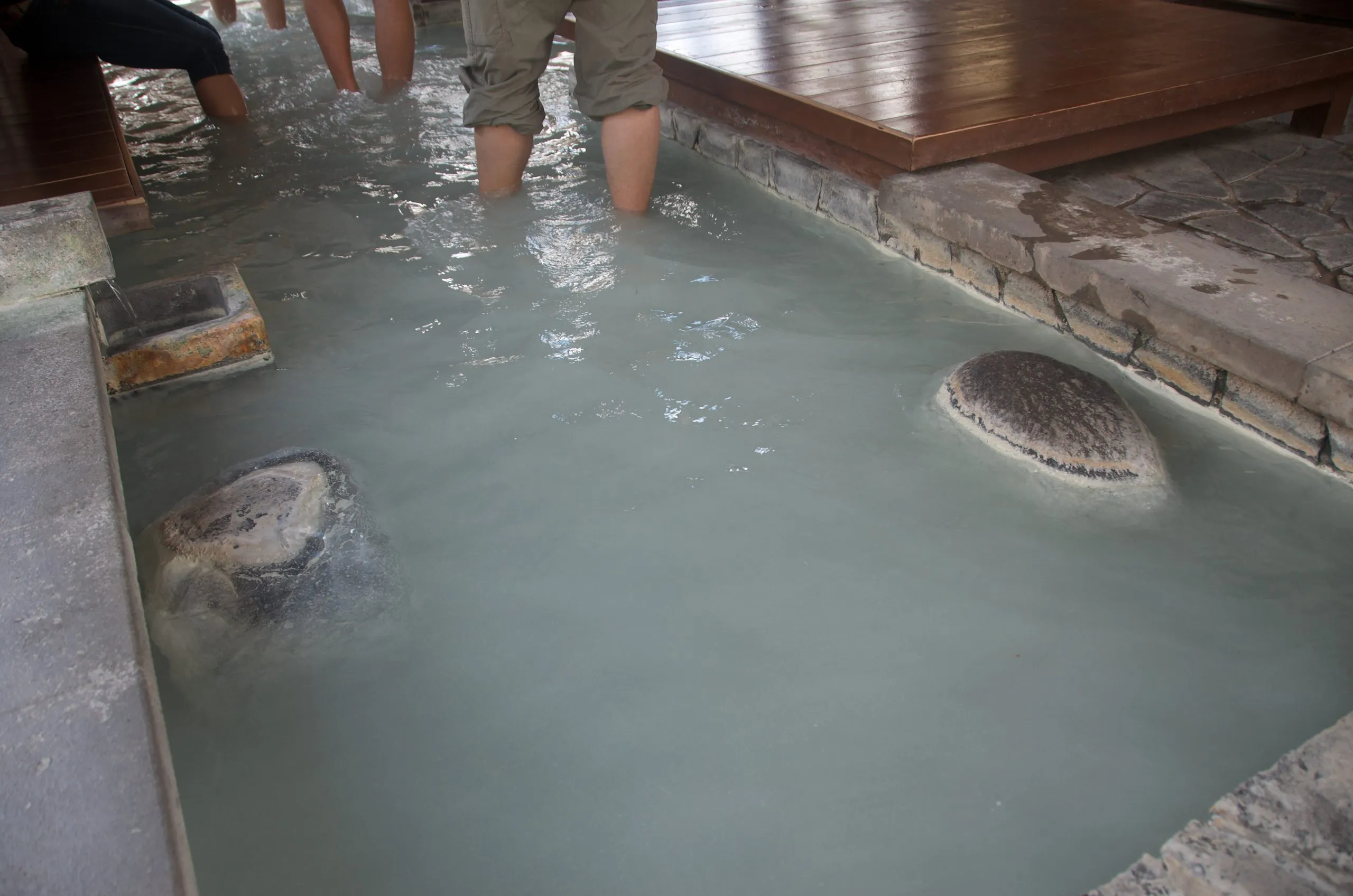 Pale sulfuric water in one section of the Anyo-no-yu foot bath, Yumoto Onsen, Nikko Japan