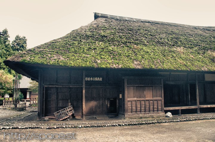 the old thatched roof workers' quarters and horse stables