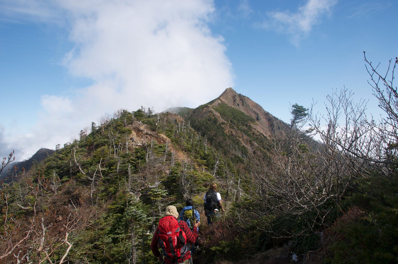 Hikers on the upper ridge with the summit ahead, Nyoho Mountain hiking trail, Nikko Japan