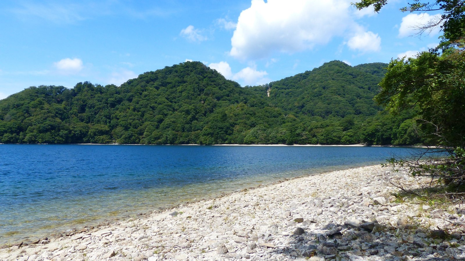 Pebble beach at Tochikubo cove looking out across the bay, Lake Chuzenji north shore trail, Nikko Japan