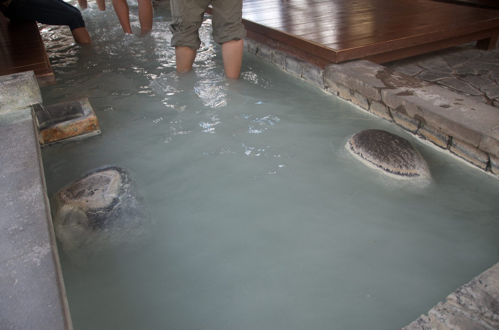 Pale sulfuric water in one section of the Anyo-no-yu foot bath, Yumoto Onsen, Nikko Japan
