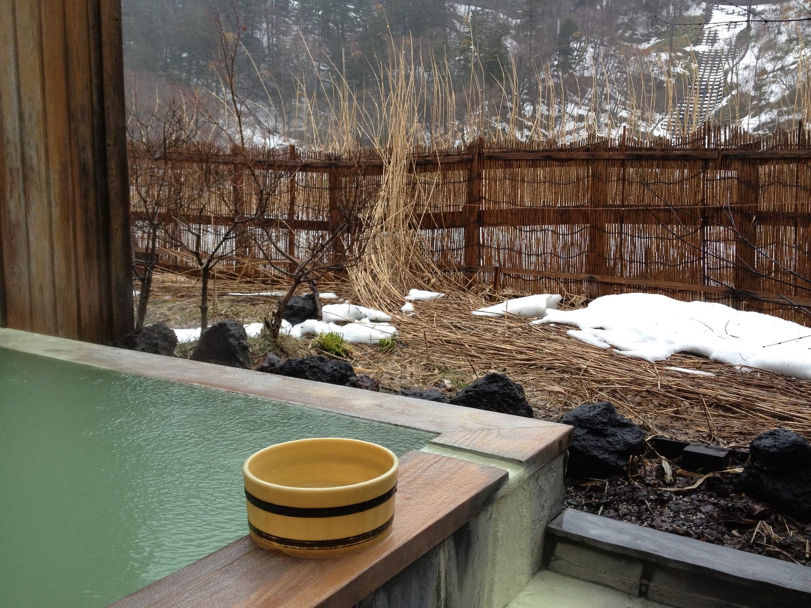 Rotenburo open-air bath with pale blue mineral water at Yumoto Onsen, Nikko Japan