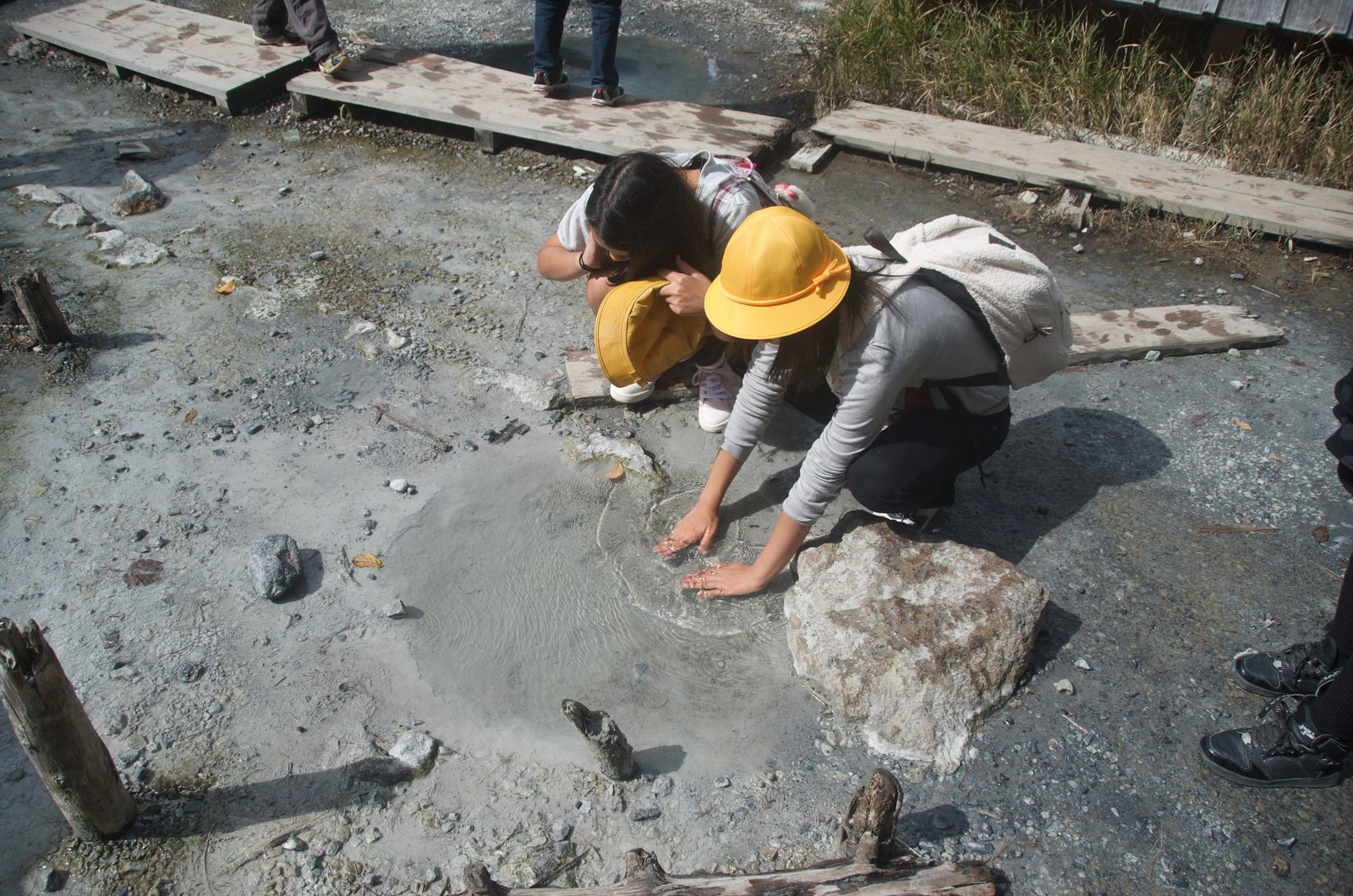Children touching warm hot spring water at Yumoto Onsen source, Nikko Japan