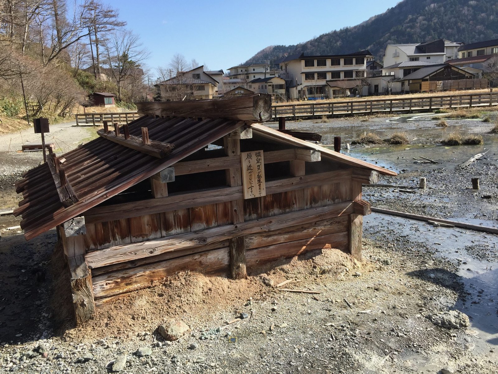Steam vent hut at Yumoto Onsen source, warning sign for hot spring gas, Nikko Japan